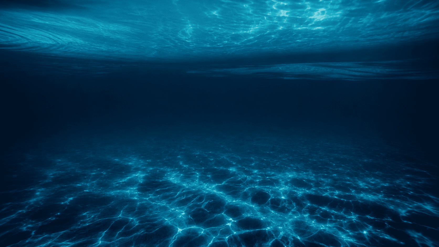 Sunlight caustics filtering through clear deep ocean waters
